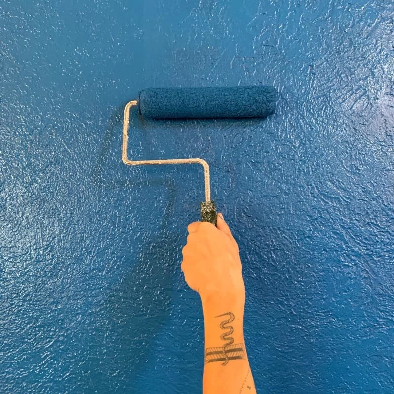 Opening renovations - arm painting blue wall